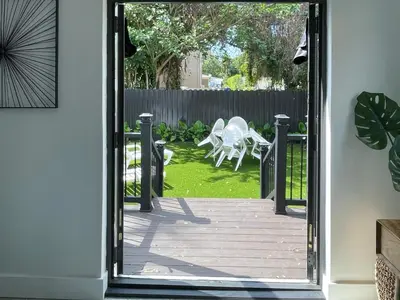 a door leading to a patio with a table and a chair at Private King Suite in Miami in Miami