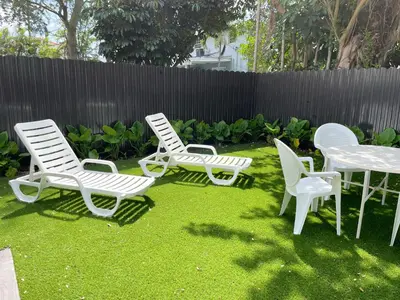 a group of chairs and a table in a yard at Private King Suite in Miami in Miami