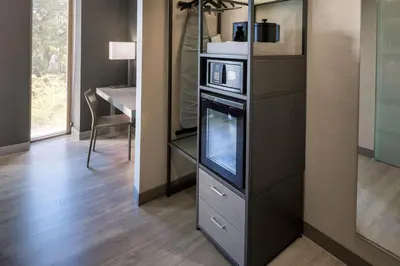 a living room with a tv and a microwave at AC Hotel Miami Wynwood in Miami