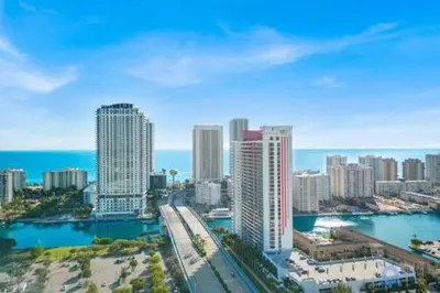 an aerial view of a city with the ocean and buildings at Upper studio Balcony Pool Gym - Near Beach in Hallandale Beach