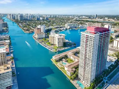 an aerial view of a city with a river and buildings at Infinite View Balcony & Pool Gym Near Beach in Hallandale Beach