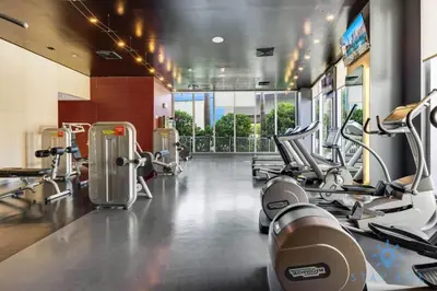 a gym with several treadmills and machines at Infinite View with Balcony and Resort, Pool, Gym in Hallandale Beach