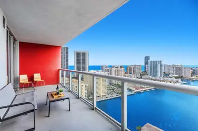 a balcony with a view of the city and the water at MODERNResortBALCONY in Hallandale Beach