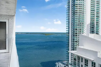 a view of the ocean from the balcony of a building at Fantastic 2BR Condo on 31st Floor Free Parking in Miami