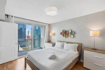 a bedroom with a bed and a large window at Fantastic 2BR Condo on 31st Floor Free Parking in Miami