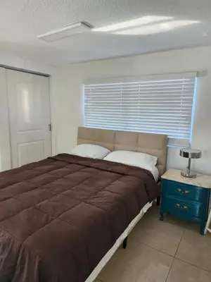 a bedroom with a large bed and a window at 1161 Studio 2 Miami in Tamiami