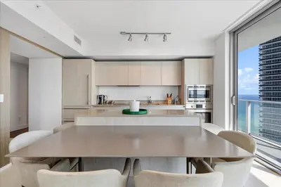 a kitchen with a large table and chairs at Ocean Views Perfect Location Resort Amenities in Hallandale Beach