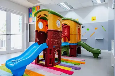 a play room with a slide and a playground at Brickell, Miami Home in the Sky! in Miami