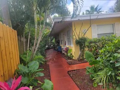 a house with a walkway in front of a yard at 4-PLEX in Fort Lauderdale