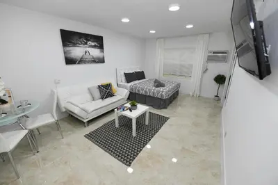 a living room with a couch and a table at 4-PLEX in Fort Lauderdale