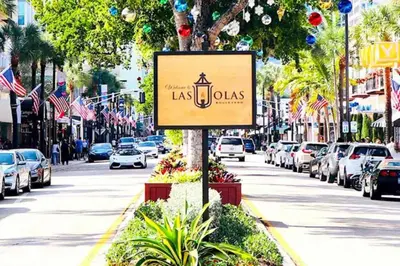a sign on a street with cars parked at 4-PLEX in Fort Lauderdale