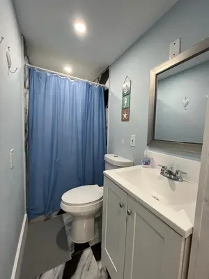 a bathroom with a toilet and a sink and a mirror at Blue Little Havana in Miami