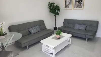 a living room with two couches and a table at Funston in Hollywood