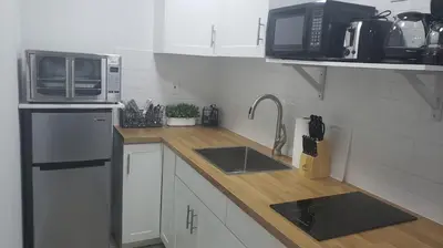 a kitchen with a sink and a microwave at Funston in Hollywood