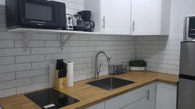 a kitchen counter with a sink and a microwave at Funston in Hollywood
