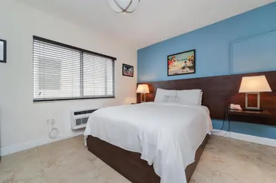 a bedroom with a large white bed and a window at Starlite Hotel in Miami Beach