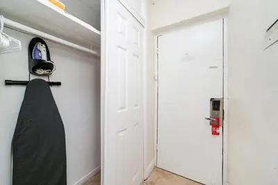 a closet with a white door and a black bag at Starlite Hotel in Miami Beach