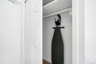 a black dress hanging on a door in a room at Starlite Hotel in Miami Beach