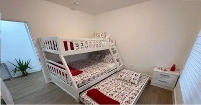 a white bunk bed in a room at Enjoy our brand new home close to Hollywood in Hallandale Beach! in Hallandale Beach