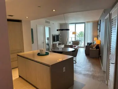 a living room with a kitchen and a living room with a couch at Lyfe-1005 in Hollywood