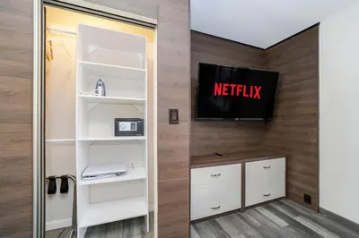 a room with white shelves and a tv on a wall at Deco Boutique Hotel in Fort Lauderdale