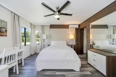 a bedroom with two beds and a ceiling fan at Deco Boutique Hotel in Fort Lauderdale