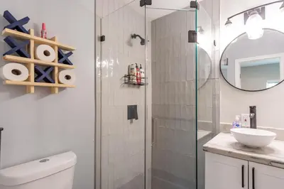 a bathroom with a shower with a toilet and a sink at Hollywood Paradise Luxury 4BR 3BA Home and Outdoor Fun with Heated Pool in Hollywood