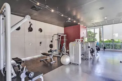 a fitness room with a gym with machines at Luxury condo with ocean view 4Bedrooms 3Bathrooms in Hallandale Beach