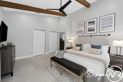 a white bedroom with a large bed and a tv at Villa wPool Firepit BBQ in Hollywood