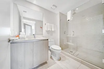 a white bathroom with a toilet and a shower at Hyde Beach House - Stunning 2bd 2ba - Apt - Ocean & Intercostal views in Hollywood