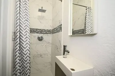 a white bathroom with a sink and a shower at Enjoy and relax around Fort Lauderdale area!! in Fort Lauderdale