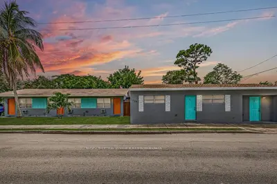 a house on the side of a street with a sunset at Enjoy and relax around Fort Lauderdale area!! in Fort Lauderdale