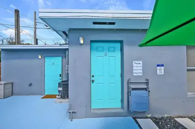a building with two blue doors on it at Enjoy and relax around Fort Lauderdale area!! in Fort Lauderdale