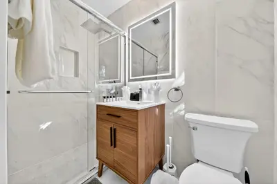 a bathroom with a toilet and a shower and a sink at Sunny 2-Bedroom Miami Retreat with a Bright, Spacious Living Area & Relaxing Outdoor Seating in Fort Lauderdale