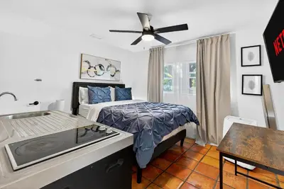a bedroom with a bed and a ceiling fan at Sunny 2-Bedroom Miami Retreat with a Bright, Spacious Living Area & Relaxing Outdoor Seating in Fort Lauderdale