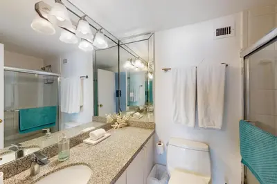 a bathroom with a toilet and a sink and a mirror at Decoplage Paradise - Main Home in Miami Beach