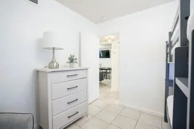 a white dresser in a room with a table at Modern 3-Bedroom in the Heart of Wynwood Art District in Miami