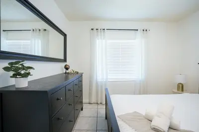 a bedroom with a mirror and a bed and a dresser at Modern 2 Bedroom in the Heart of Wynwood Art District in Miami