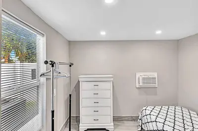 a bedroom with a bed and a dresser and a window at Modern Villa with Pool Hollywood Hard Rock Casino in Fort Lauderdale