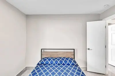a bedroom with a bed in a white room at Modern Villa with Pool Hollywood Hard Rock Casino in Fort Lauderdale