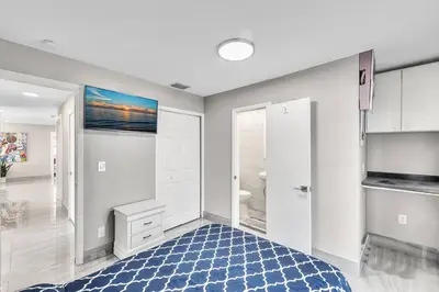 a white room with a blue rug and a bathroom at Modern Villa with Pool Hollywood Hard Rock Casino in Fort Lauderdale