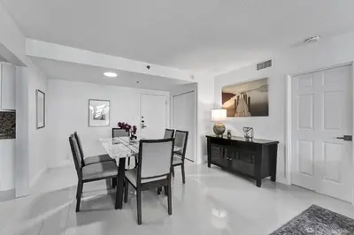 a dining room with a table and chairs at Cozy Beachfront 2 BDR & 2 BA Miami Beach Condo in Miami Beach