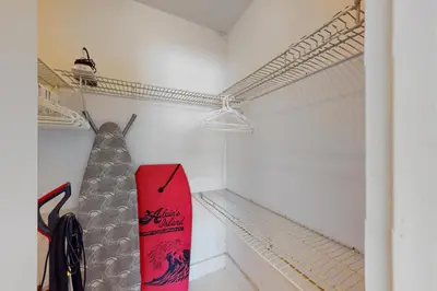 a red snowboard is hanging in a closet at Decoplage Paradise - Unit B in Miami Beach