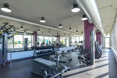 a gym with rows of treadmills and machines at Decoplage Paradise - Unit B in Miami Beach