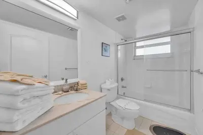 a white bathroom with a sink and a shower at Ocean View Amazing Unit Brickell in Miami