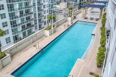 an overhead view of a large swimming pool in a building at Ocean View Amazing Unit Brickell in Miami