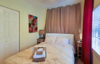 a small bedroom with a bed and a window at Artful 3BR Oasis in Little Haiti, Miami in Miami