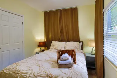 a bedroom with a bed with a towel on it at Artful 3BR Oasis in Little Haiti, Miami in Miami