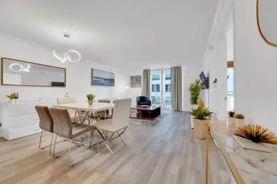 a dining room and living room with a table and chairs at Impressive Unit in the heart of Brickell W Parking in Miami