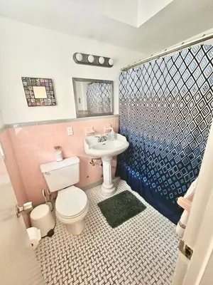 a bathroom with a white toilet and a sink at Coral Gables / Coconut Grove area FREE parking in Miami